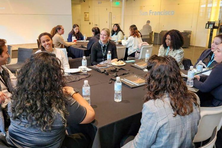 students sit at a table inside Bloomberg offices