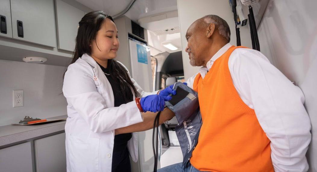 药学博士学生和病人 in mobile clinic van